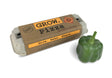 The Grow Pizza garden kit in package alongside a fresh green bell pepper