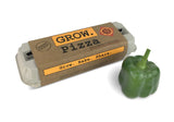 The Grow Pizza garden kit in package alongside a fresh green bell pepper