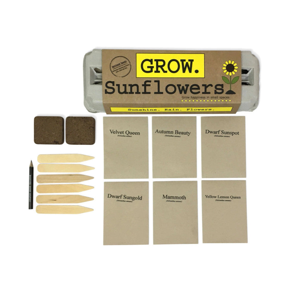 the package and contents of the grow sunflowers garden kit: seeds, starter soil, wooden plant ID sticks, pencil, growing instructions
