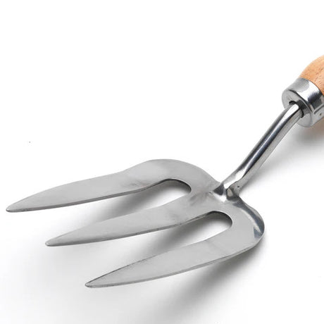 a close up of the head of the hand fork against a white background