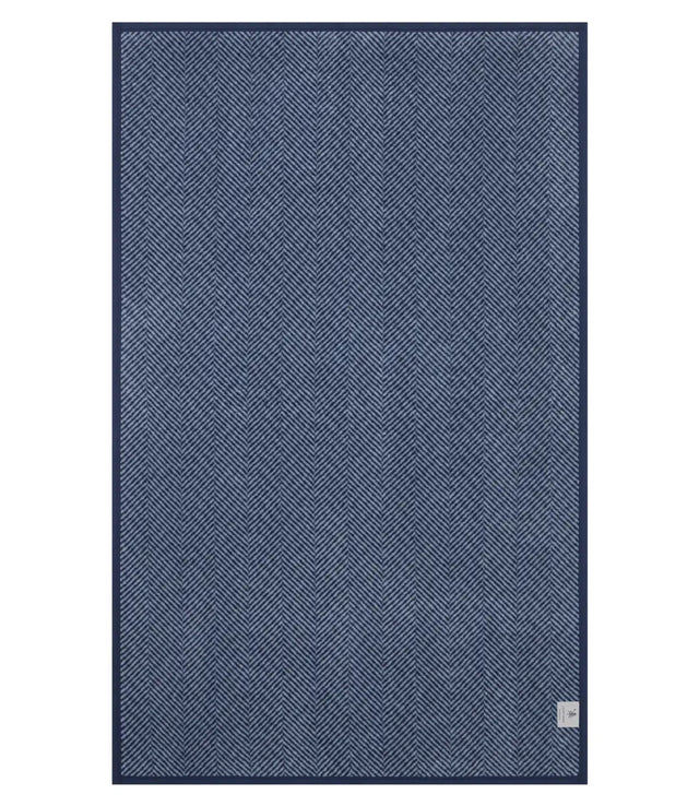 The back of the Harborview Herringbone Navy Blanket showing the mirror image and reverse color of the full size and Herringbone design in Navy and Fog color scheme