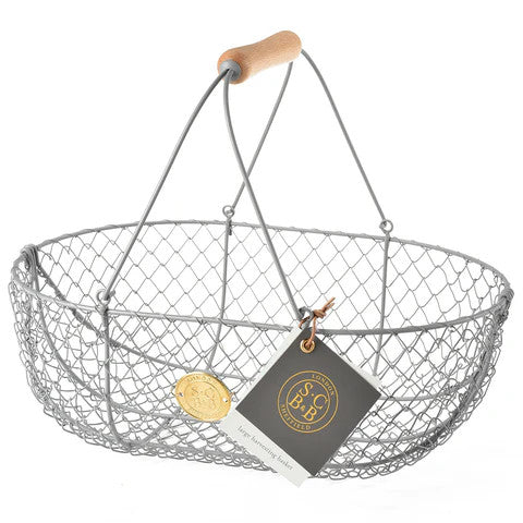 the large harvest basket with gray metal body and wooden handle and manufacturer tag