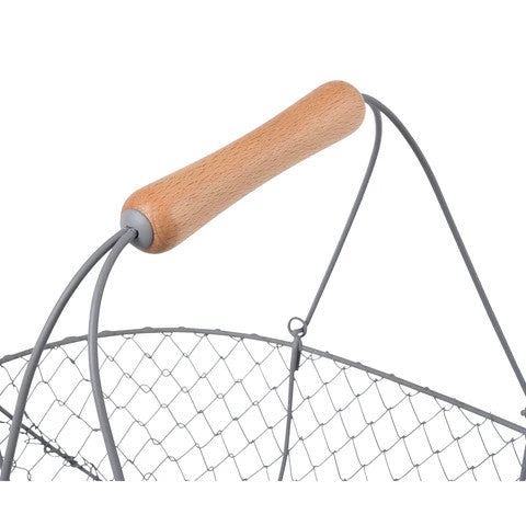 a close up of the smooth wooden handle on the large harvest basket