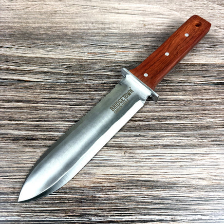 Knife with a wooden handle on a wooden surface