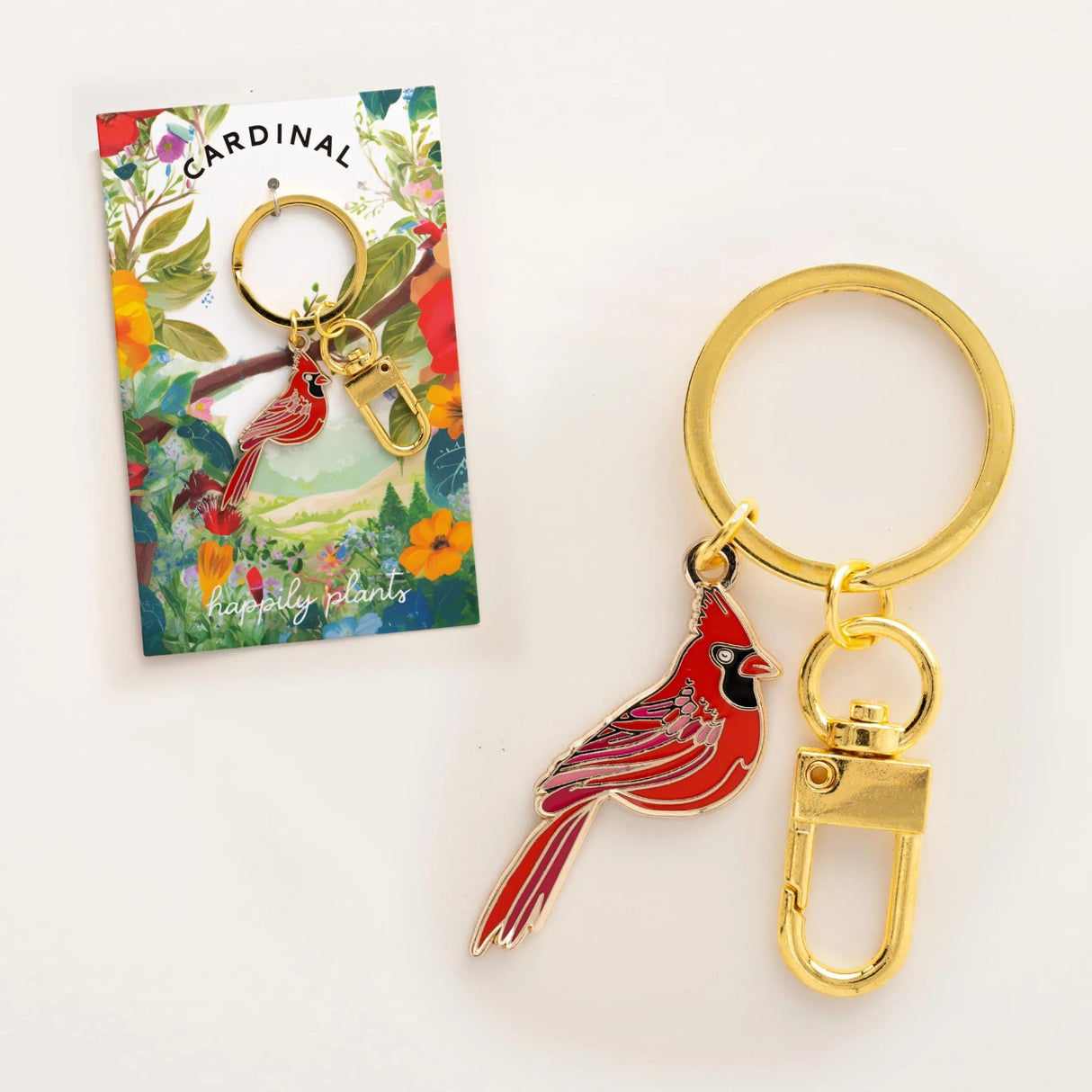 Cardinal keychain with gold clip on a white background