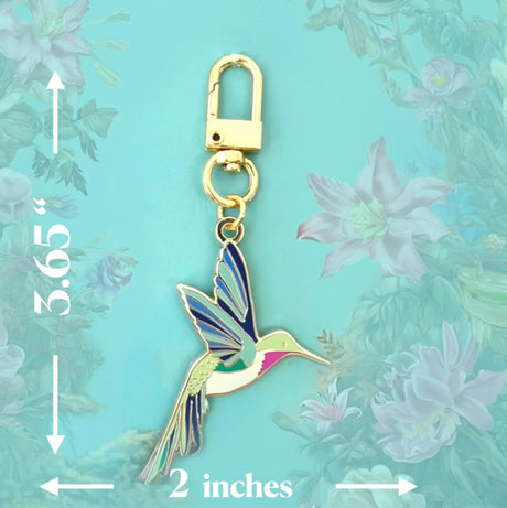 Hummingbird keychain with measurements on a floral background