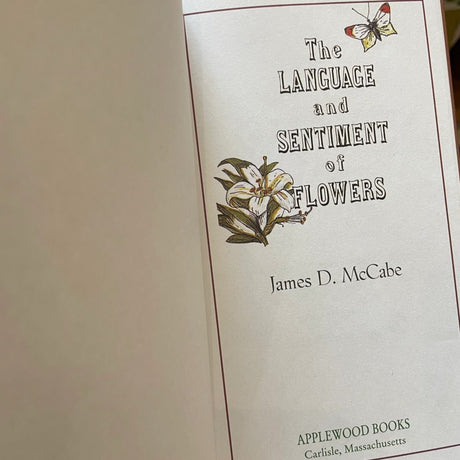 Book cover of 'The Language and Sentiment of Flowers' by James D. McCabe with floral illustrations.