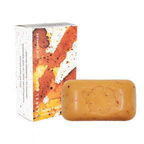 the Spice Loofa soap box with warm abstract color design alongside a bar of the soap