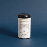 the backside of the lapsang souchong tea tin against a deep blue background