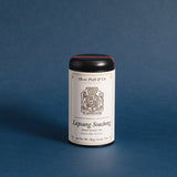 the lapsang souchong tea tin against a deep blue background