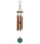 A hanging wind chime with multiple copper-toned metal tubes, a dark top cap and hook, and a round turquoise-green hanging disc below, shown on a plain white background.