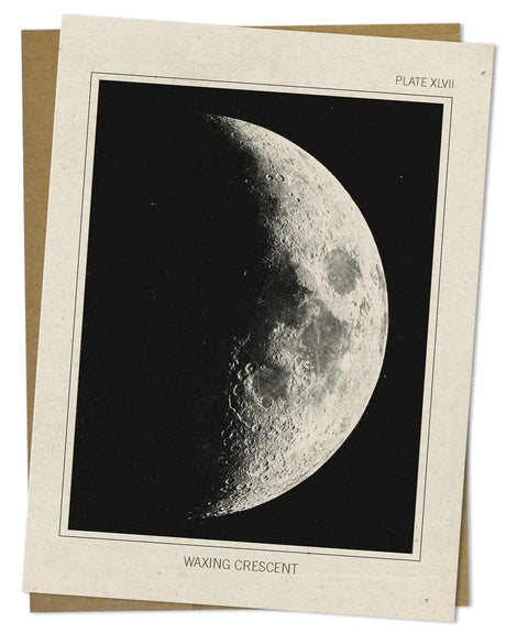 a close up look of the details of an off white greeting card with a vintage image of the moon in its waxing crescent phase
