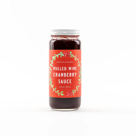 Jar of mulled wine cranberry sauce with a decorative label on a white background
