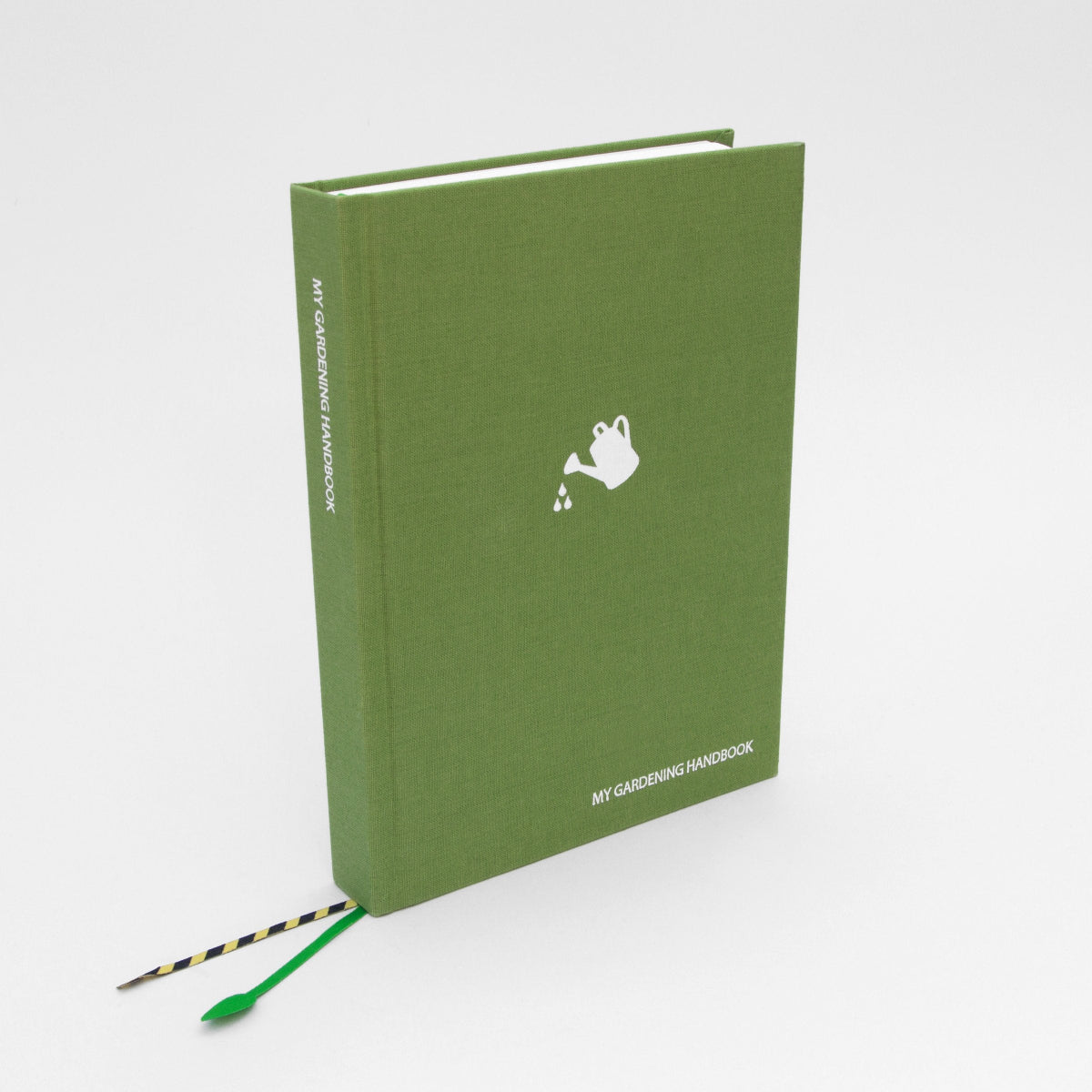 Green notebook titled 'My Gardening Handbook' with a white watering can logo on a white background