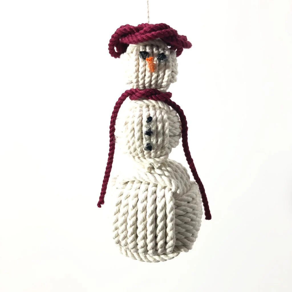 a handmade snowman ornament made of monkeyfist sailor knots with a burgundy scarf and burgundy hat