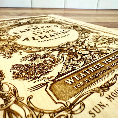 close up of the detail of the engraving on the 'Old Farmer's Almanac' cutting board featuring intricate designs and text.