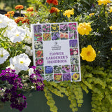 Flower Gardener's Handbook by The Old Farmer's Almanac surrounded by colorful flowers