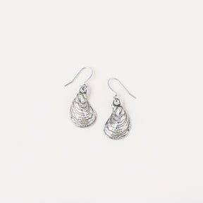 a pair of pewter oyster shell shaped earrings on a white background