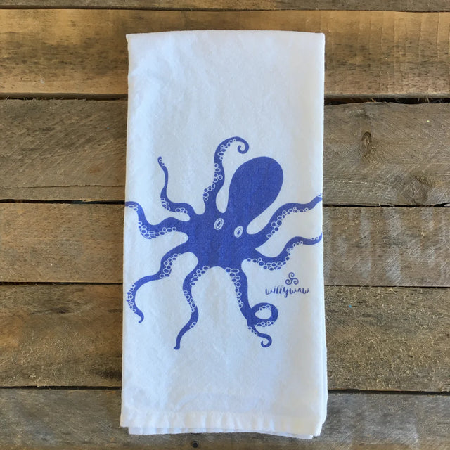White towel with blue octopus design on a wooden surface