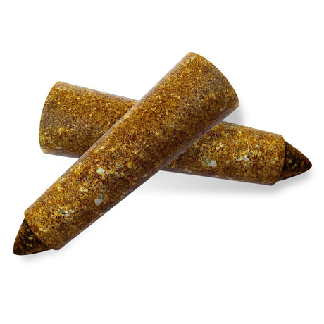 Three brown cylindrical dog treats on a white background