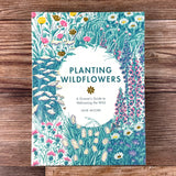 Book cover of 'Planting Wildflowers' by Jane Moore on a wooden surface