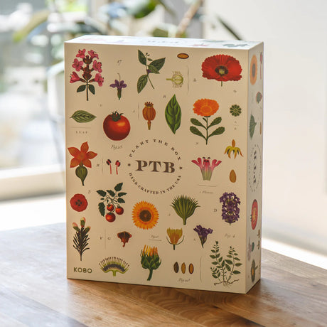 Kobo plantable box with botanical designs on a wooden surface