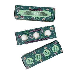 Three boxes of bath bomb sets with floral designs and text on a white background
