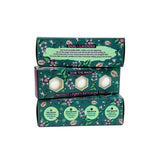 Three stacked bath bomb boxes with green and purple designs on a white background