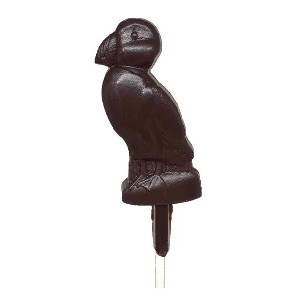 a dark chocolate pop, crafted in the charming shape of a puffin against a white background
