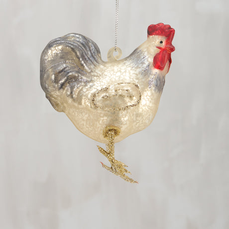 Decorative glass rooster ornament on a plain background