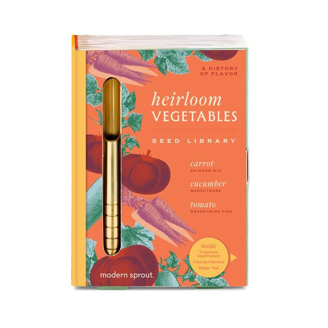 Seed library book titled 'Heirloom Vegetables' with a gold tool on an orange background