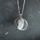 Silver necklace with a pendant on a dark background