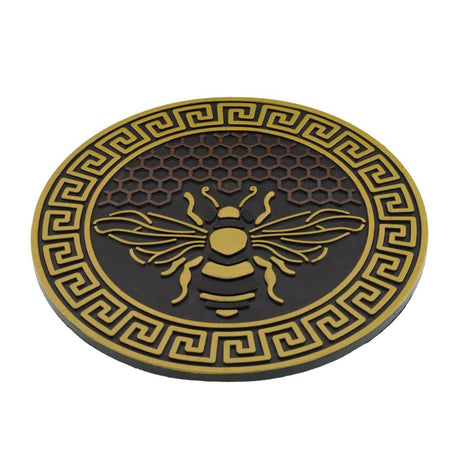 garden stepping stone with bee design and honeycomb background in yellow and brown shown at a slight angle