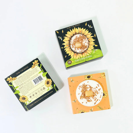 Three boxes with sunflower designs on a white background