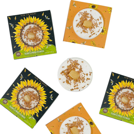 An array of Sunflower Power bath bombs in their sunflower themed packaging with a bath bomb in the center