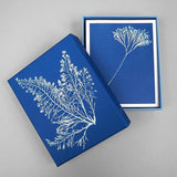 Blue box with white floral design on a gray background