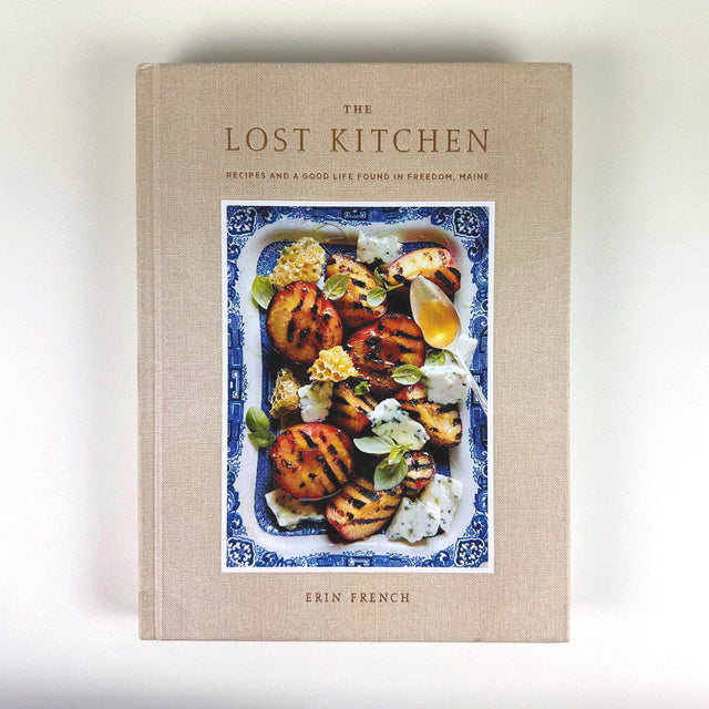 Cookbook titled 'The Lost Kitchen' by Erin French on a light background