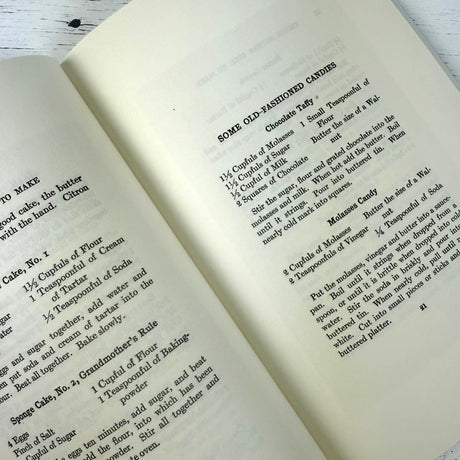 Open book with vintage-style recipe text on a wooden surface