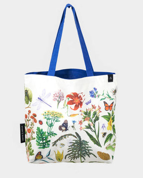 side two of the pollinator tote; a white tote bag with blue straps covered in vintage illustrations of hummingbirds, bees, butterflies, and the plants they pollinate