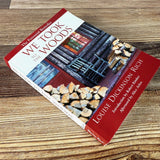 We Took to the Woods book on rustic wood surface shown laying diagonally