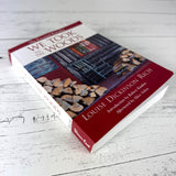 We Took to the Woods book on rustic white wood, shown at a slight side angle so the spine is visible