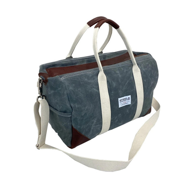 a front/side angle view of the waxed briquette weekender bag