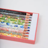 Set of colored pencils with floral designs in a pink box on a white background