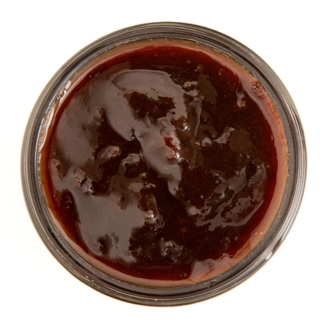 top view of the Spiced Plum with Port with the jar lid open showing the rich, deep purple color of the preserves