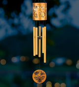 an illuminated view of the bee chime in a garden at night