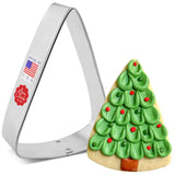 a triangle wedge cookie cutter next to a fully decorated cookie made to look like a Christmas tree