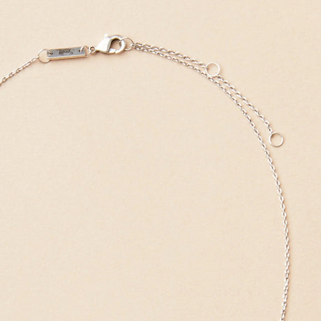 close up of the gold chain that goes with the gibbous slice silver necklace