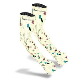 the protection sleeves in a creamy off white color with a repeated pattern of dragonflies, flowers, and leaves