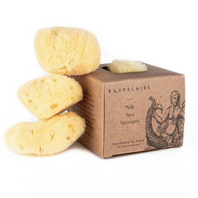the silk facial sponge box next to a stack of 3 silk sponges