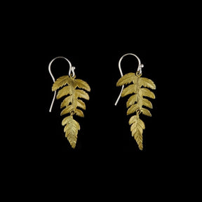 a pair of earrings bronze cast from real fern leaves with green patinated leaves hanging from silver earring wire